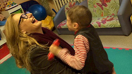 Sonja Dinner visiting St. Petersburg in 2014, engaging with one of the residents. Our partner organisation, Perspektivy, ensures that children with multiple severe developmental disorders receive high levels of care and interaction.